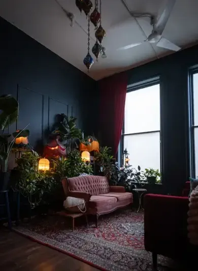 Cozy counselling room with a red sofa, warm lighting, plants, and a calm atmosphere